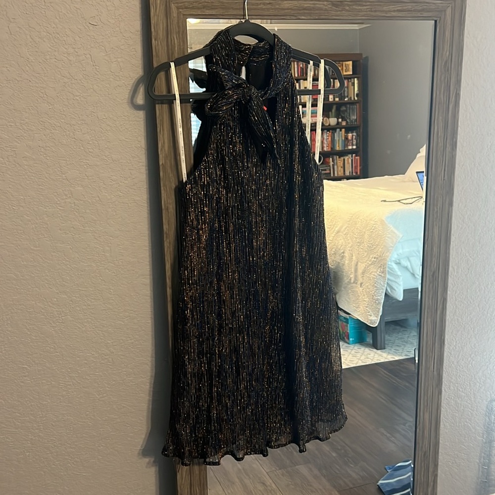 Fun and flouncy dress! Bow neckline and stunning sequins throughout.
